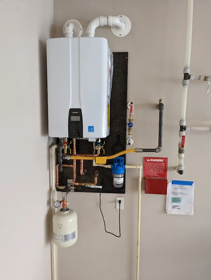 Professional plumber installing copper piping in a Biscayne Park home